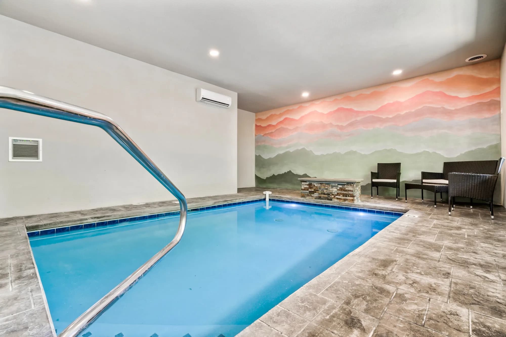 Luxury indoor pool with stone accents