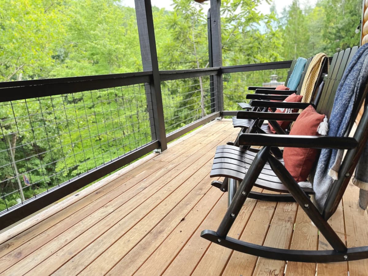 Private deck with forest views at Whispering Pines Lodge in Sevierville, surrounded by autumn foliage